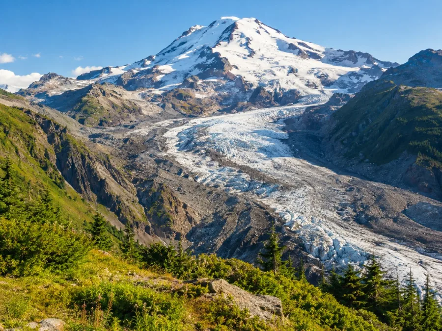 The grey ice and moraine of the Nisqually Glacier seen from a viewpoint